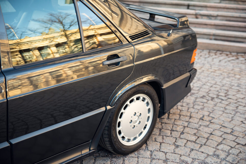 Black vintage car parked on cobblestone street