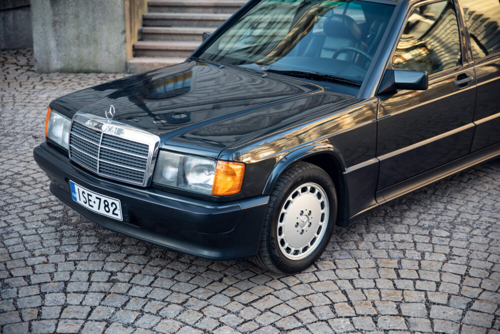 Vintage black Mercedes-Benz car parked on cobblestone street