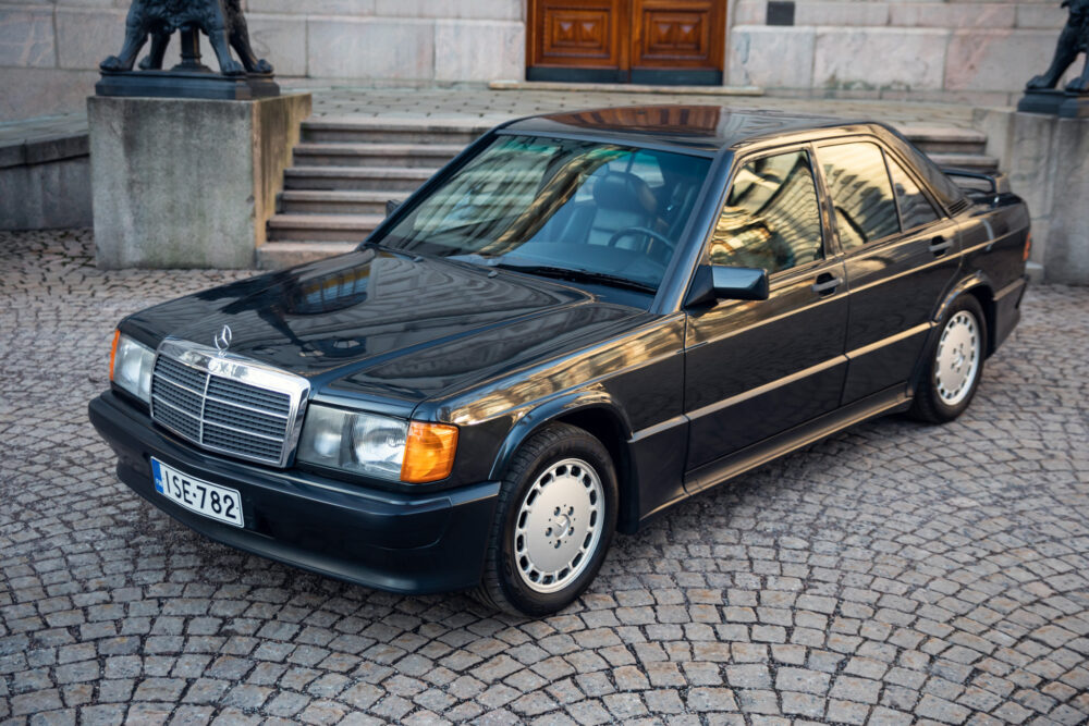 Vintage black Mercedes-Benz parked by cobblestone street