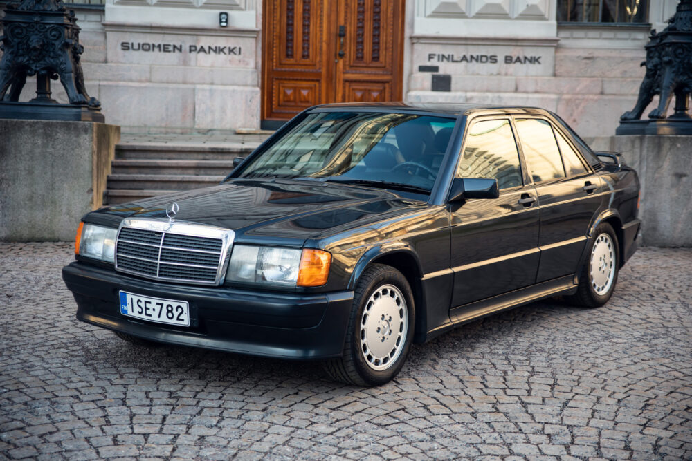 Vintage Mercedes sedan parked in front of stone building