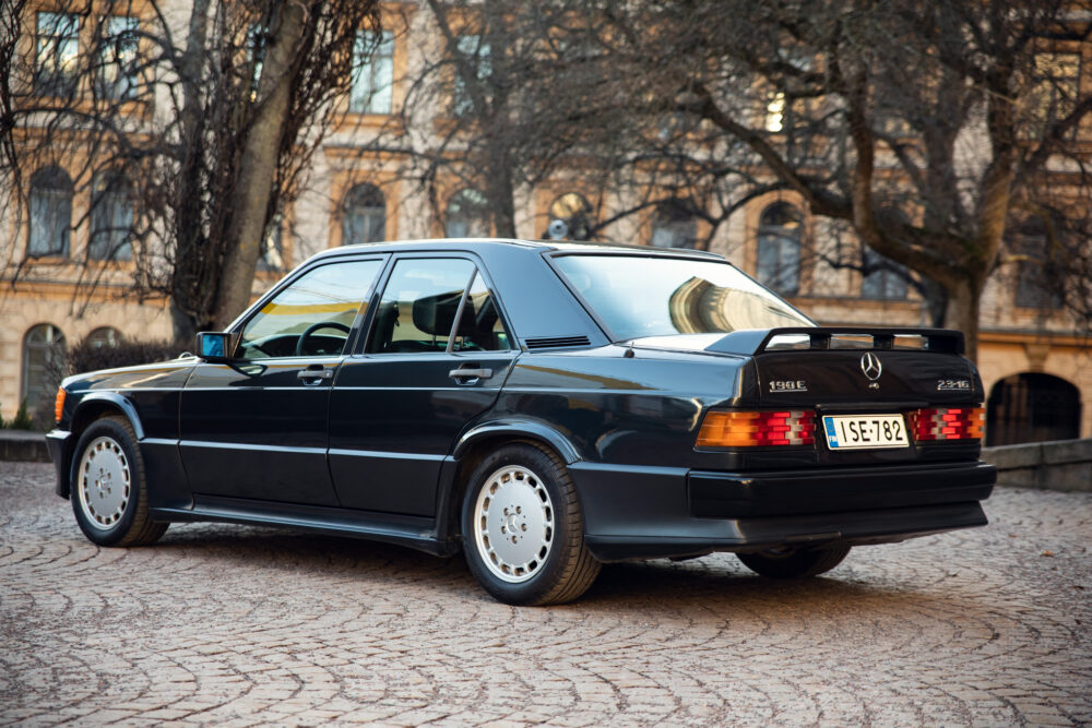 Vintage Mercedes-Benz 190E parked on cobblestone street