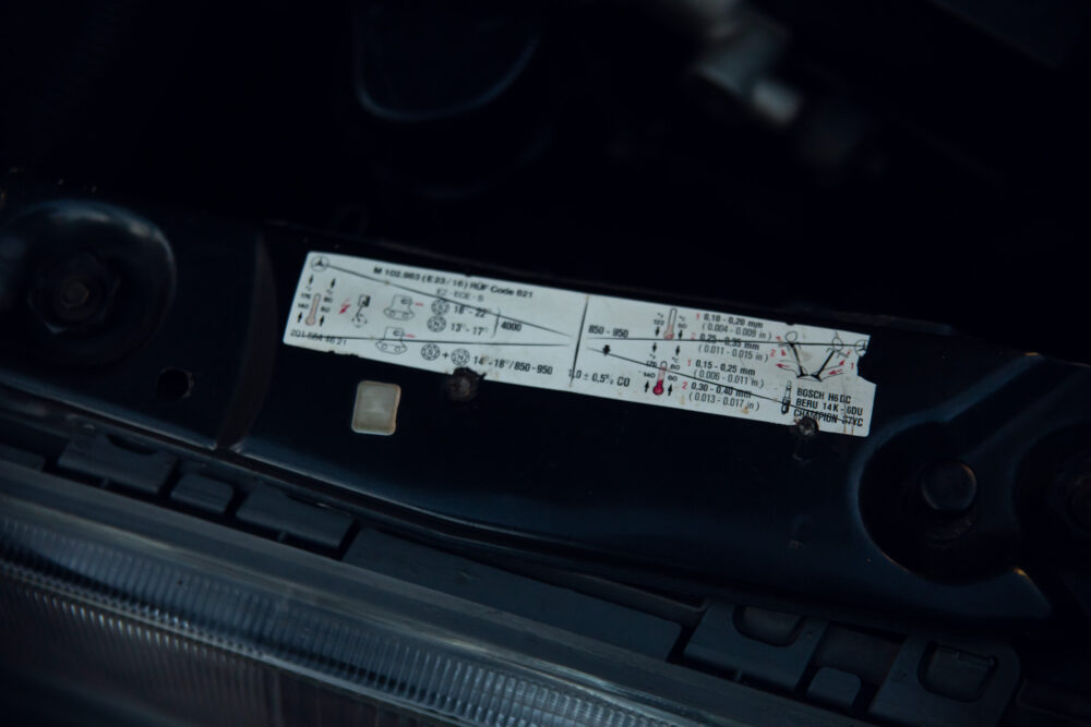 Close-up of vehicle specification label under hood