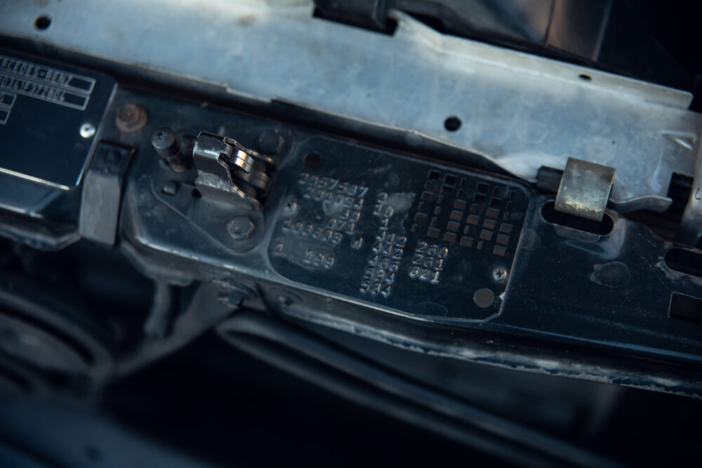 Close-up of car battery terminal and code label