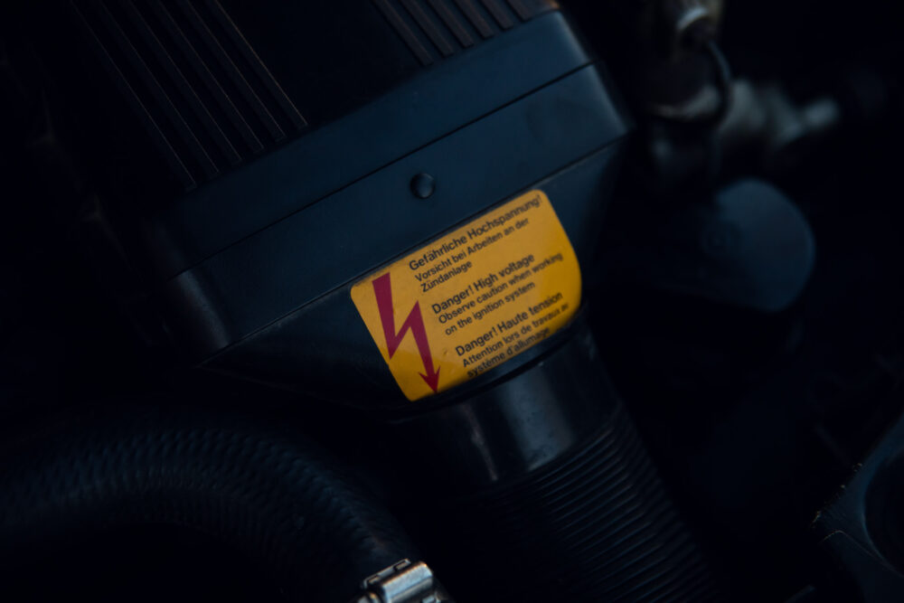 High voltage warning label on engine component