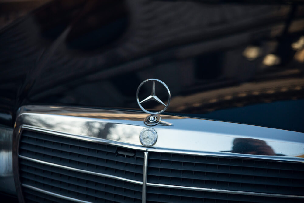 Close-up of Mercedes-Benz logo on car grille