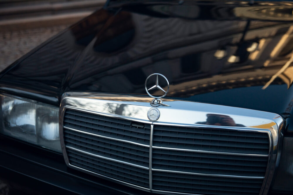 Close-up of Mercedes-Benz emblem on car grille