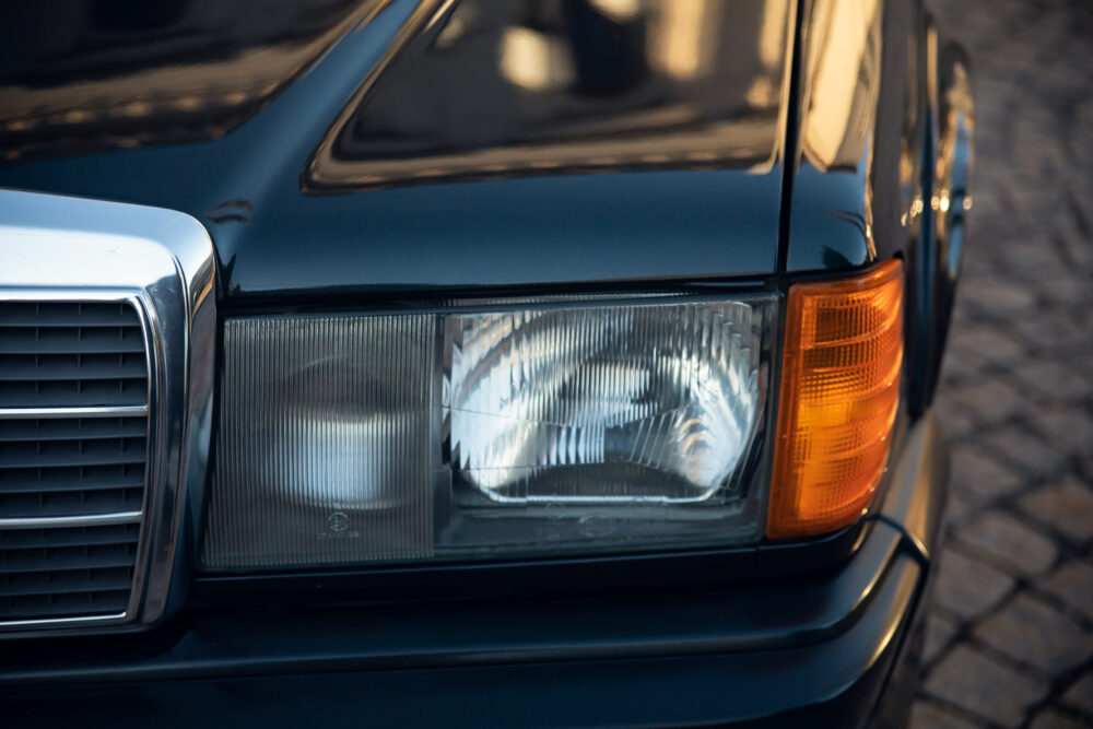 Close-up of vintage car headlight and grille