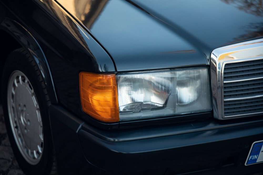 Close-up of vintage car headlight and grille