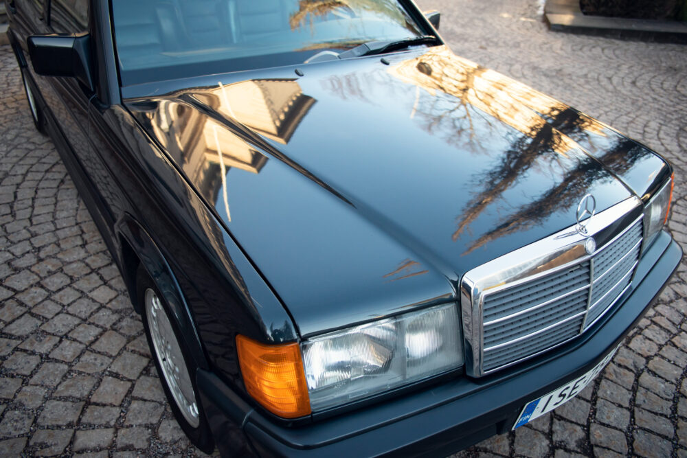 Vintage Mercedes-Benz sedan parked on cobblestone street