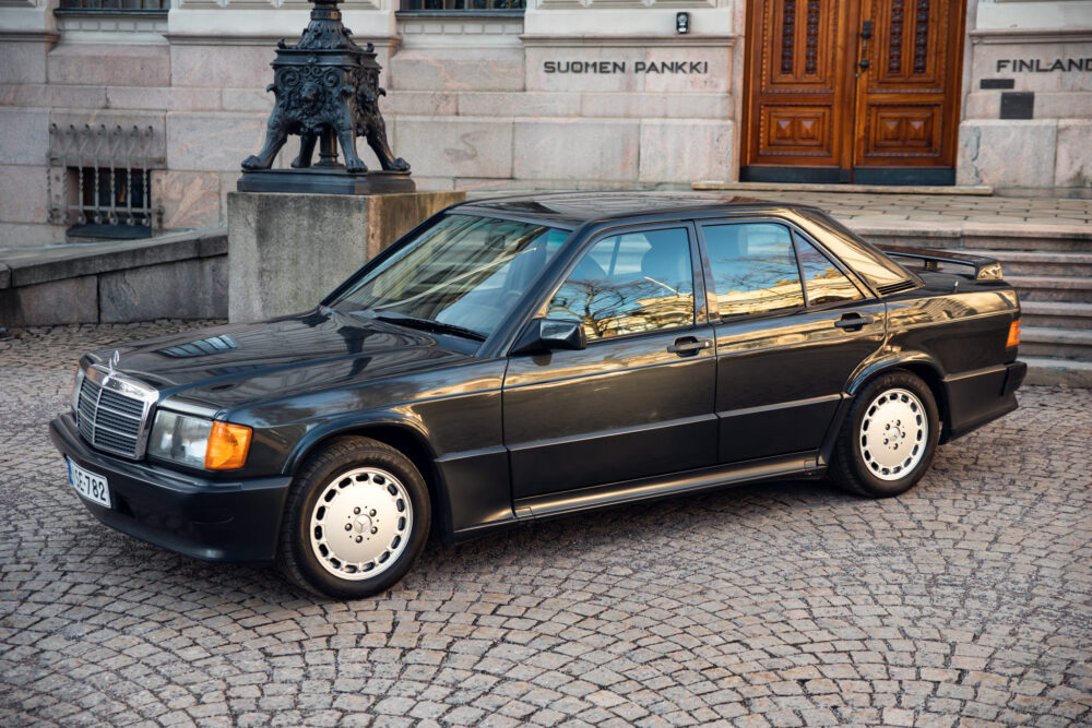 Vintage black Mercedes parked in front of building