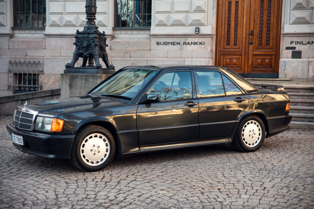 Vintage black Mercedes parked outside historic building