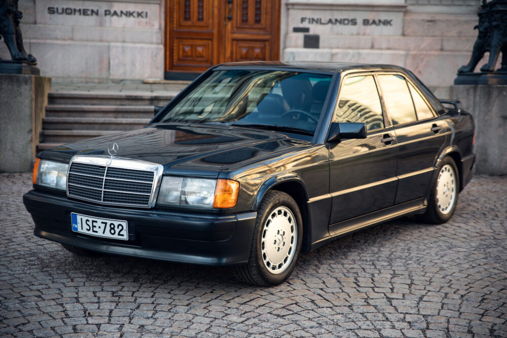 Vintage Mercedes-Benz parked in front of historic bank