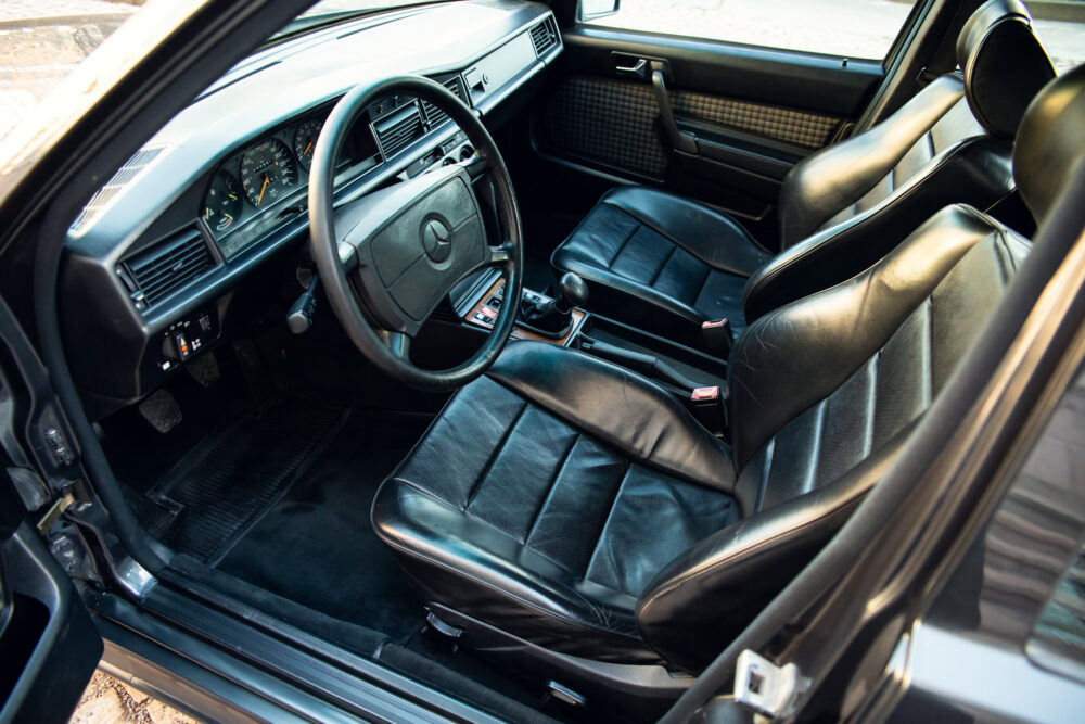 Vintage car interior with black leather seats and dashboard