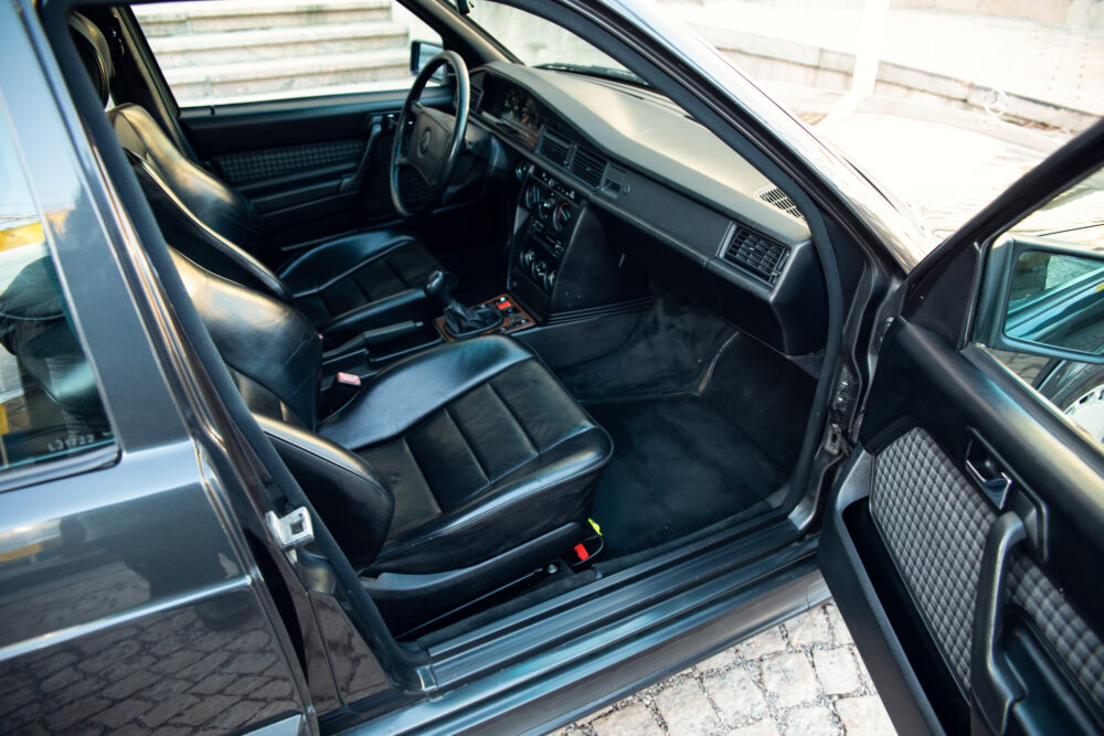 Open driver's side door of a classic luxury car