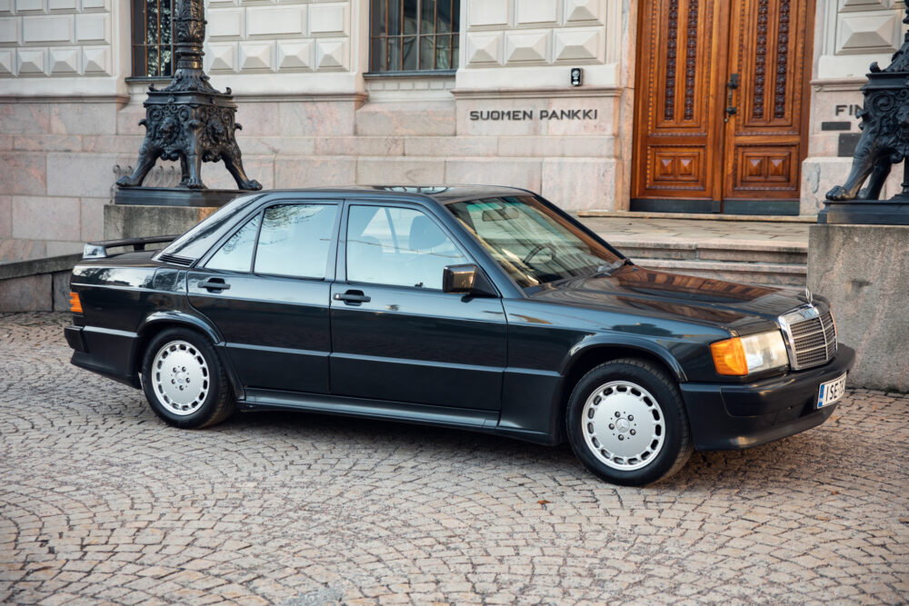 Vintage black sedan parked outside Suomen Pankki building