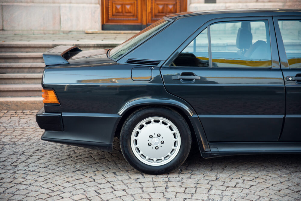 Classic black car parked near stone staircase