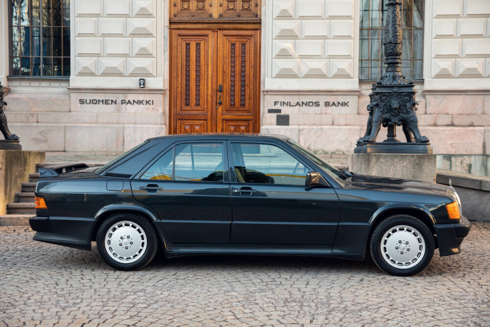 Black vintage car parked outside Finland's Bank building