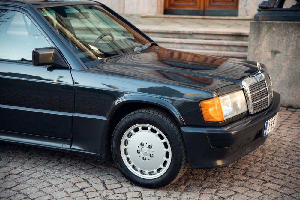 Black vintage sedan parked on cobblestone street