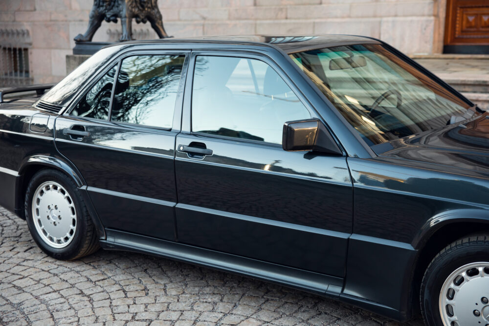 Classic black sedan parked near historical building