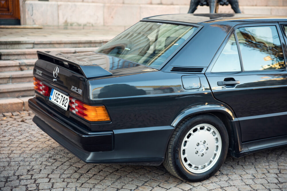 Vintage Mercedes-Benz 190E parked on cobblestone street