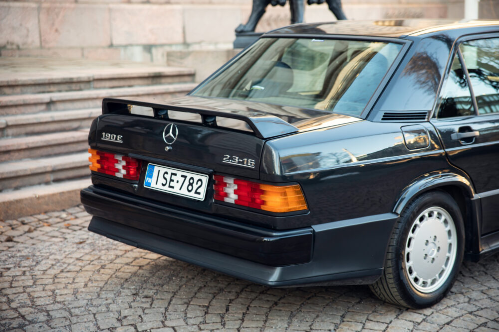 Vintage Mercedes 190E parked on cobblestone street