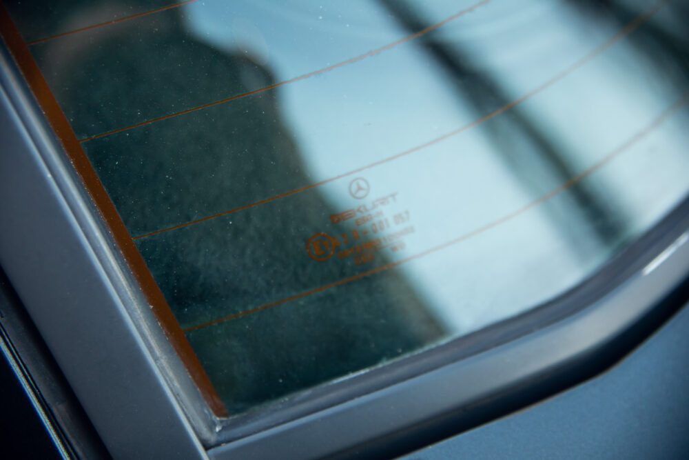 Close-up of car window safety standard markings