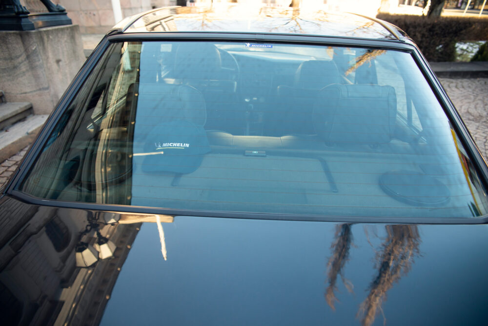 Car windshield with Michelin branding and street reflections