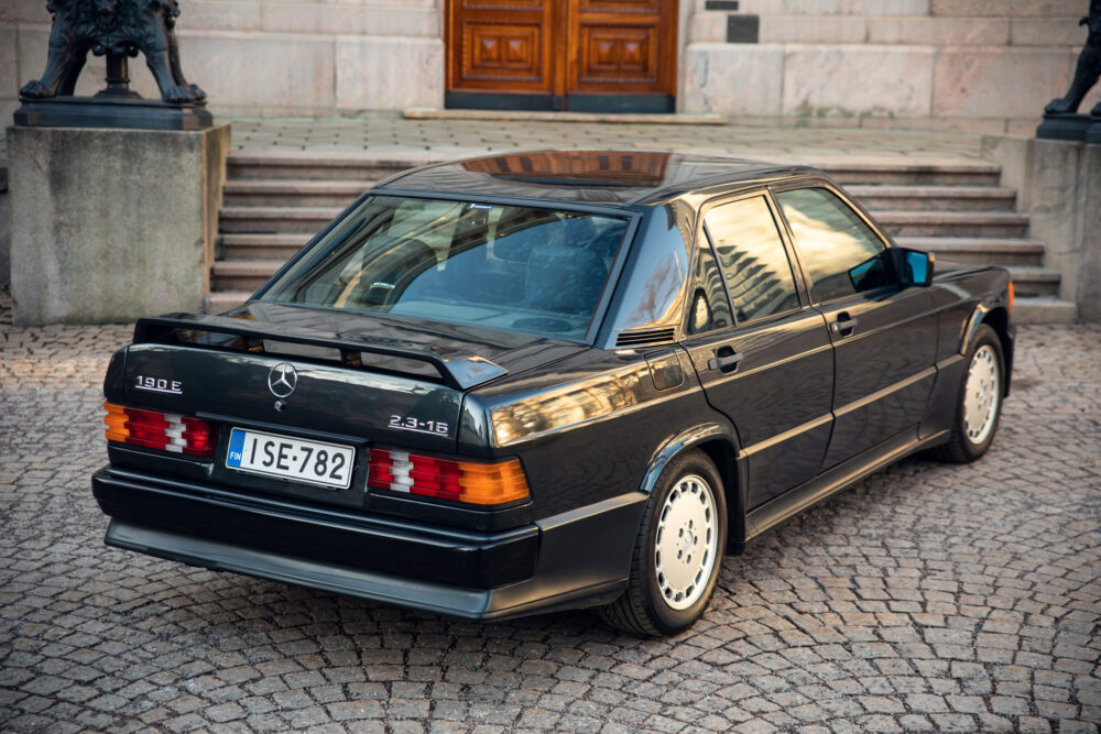 Vintage Mercedes-Benz 190E parked on cobblestone street