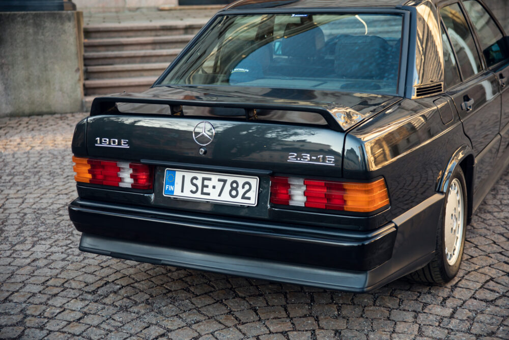 Vintage Mercedes-Benz 190E parked on cobblestone street