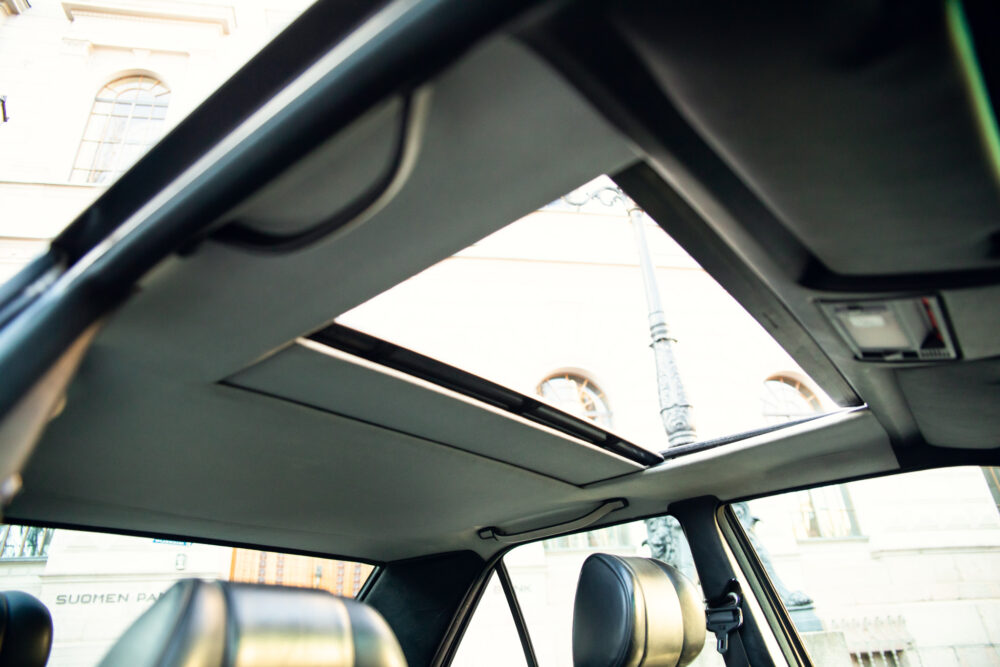 View through car sunroof showing urban architecture