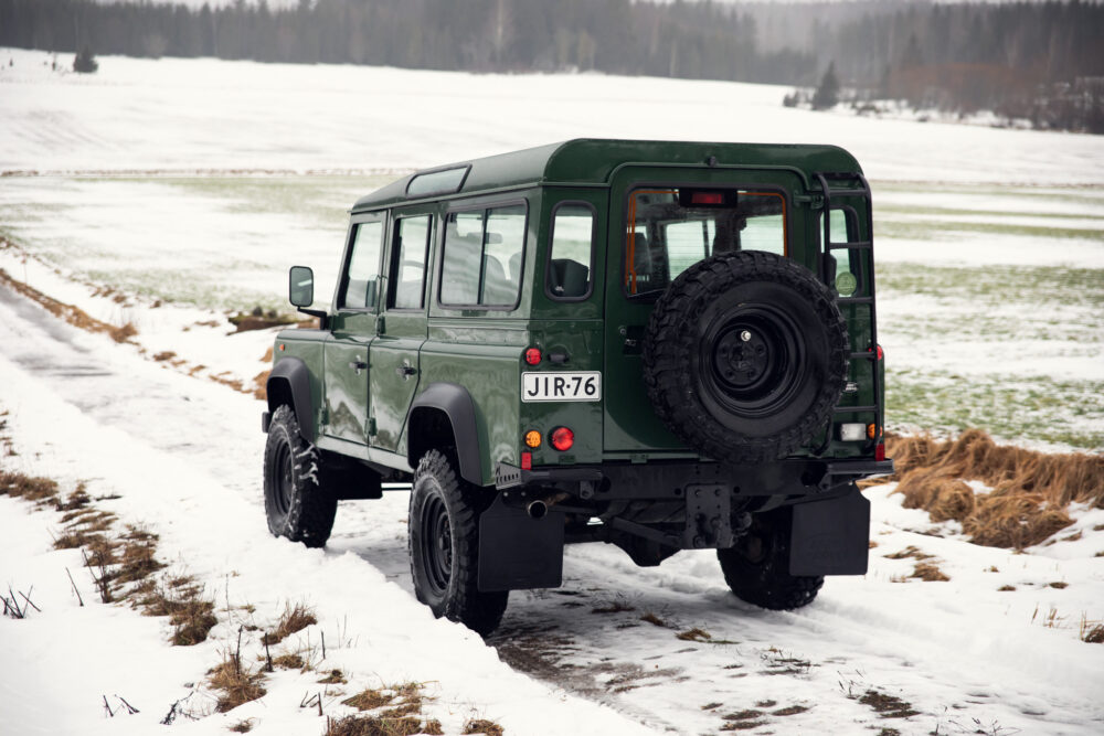 Green SUV on snowy field