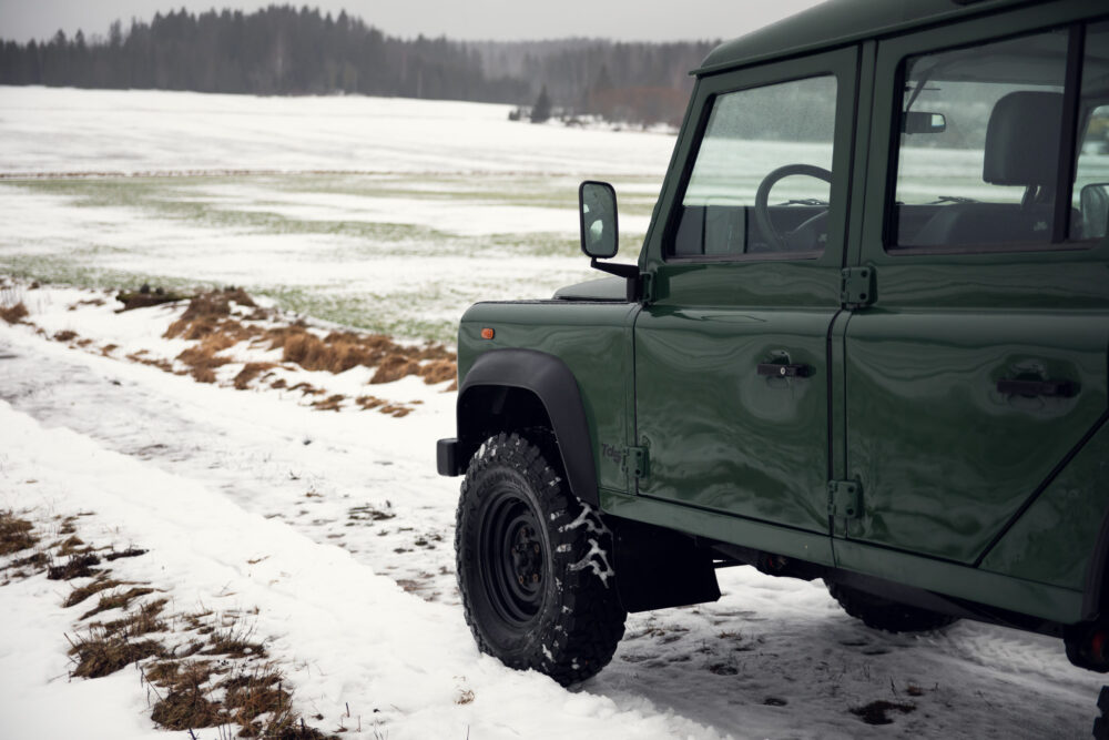 Green off-road vehicle on snowy field