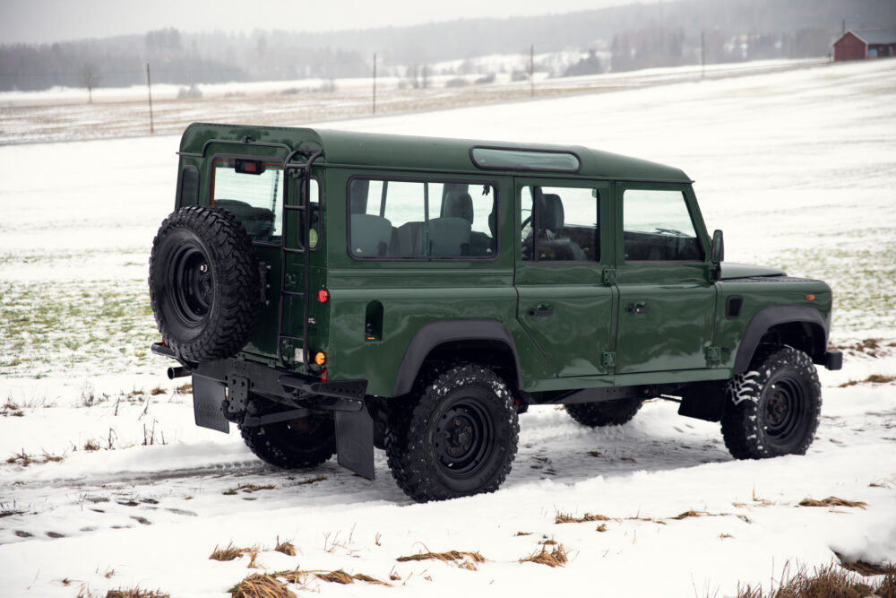 Green SUV on snowy field