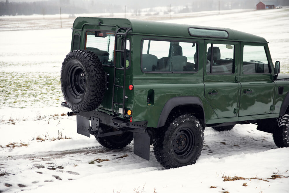 Green off-road vehicle in snowy field