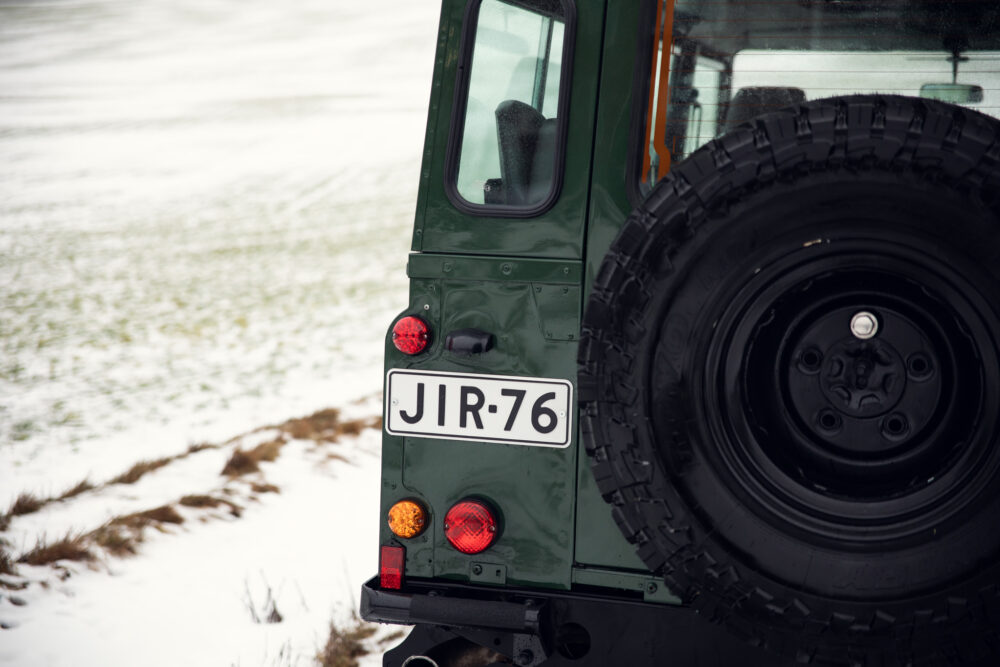 Green jeep rear view in snowy field