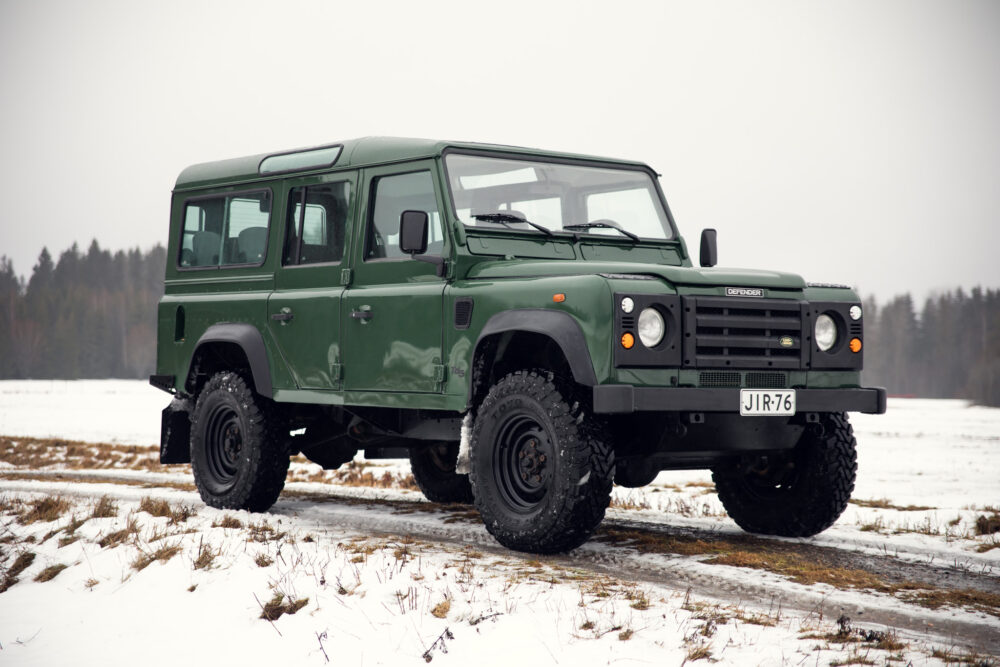 Green off-road vehicle on snowy field