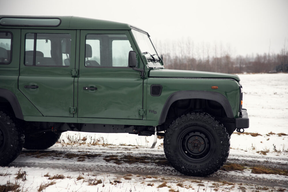 Green off-road vehicle on snowy field