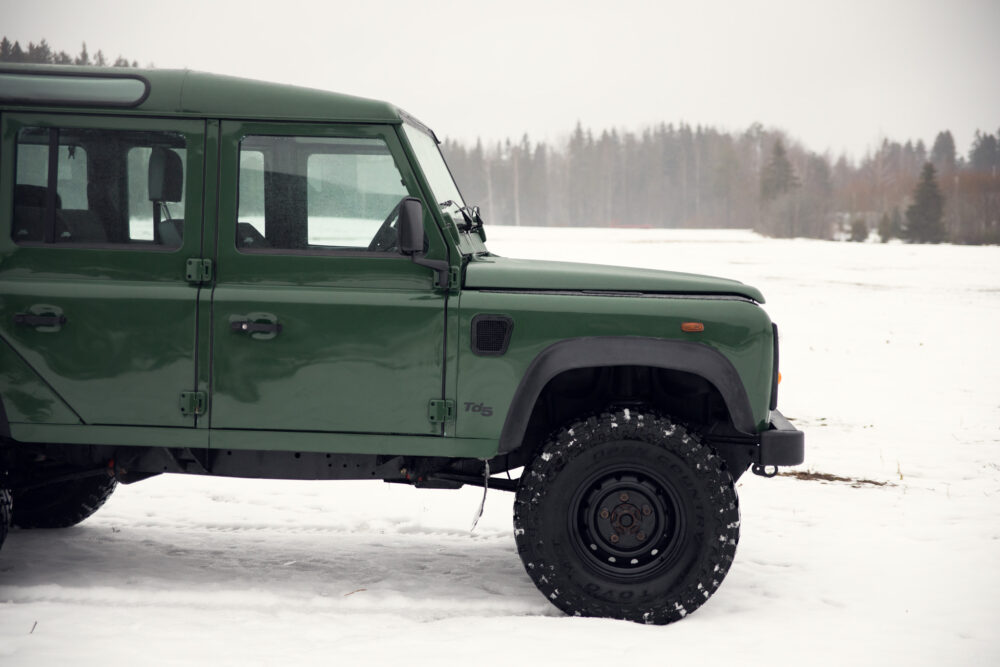 Green SUV on snowy field