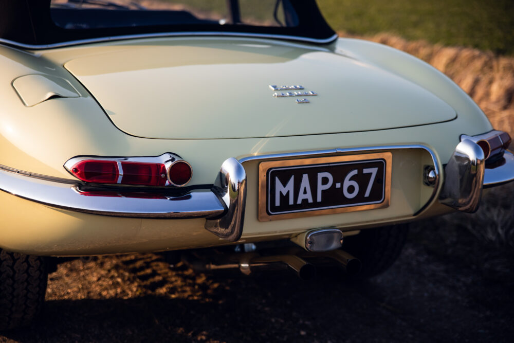 Vintage cream car rear with MAP-67 license plate