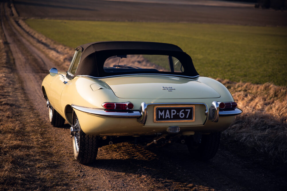 Vintage yellow convertible car on countryside dirt road