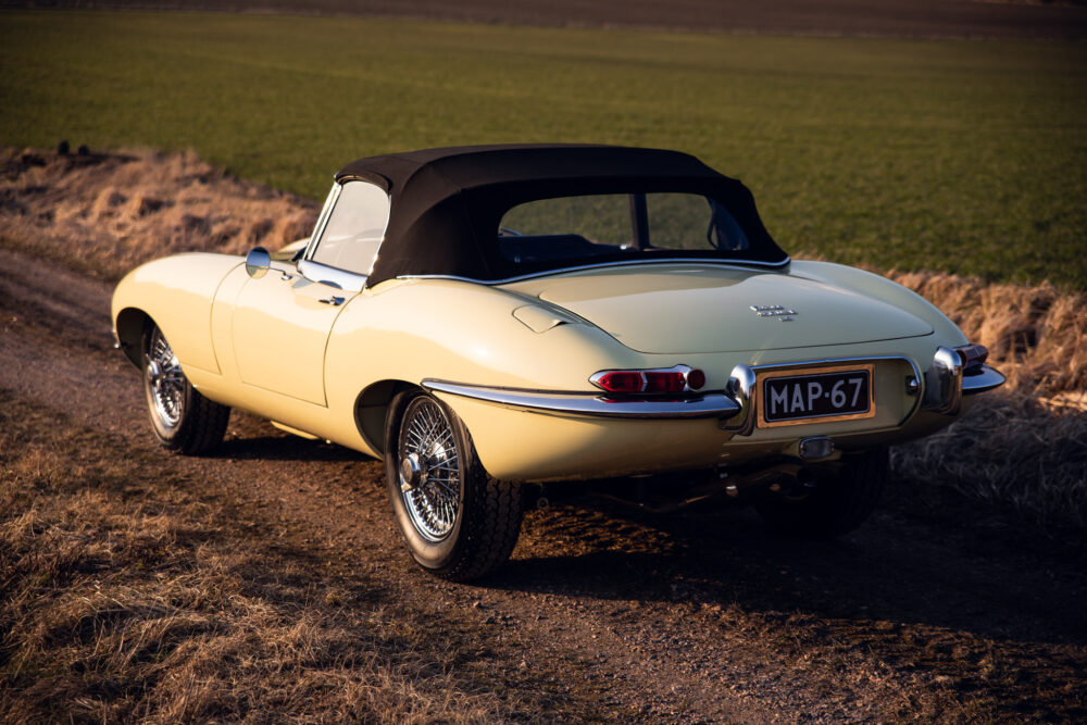 Vintage beige convertible car parked in rural setting