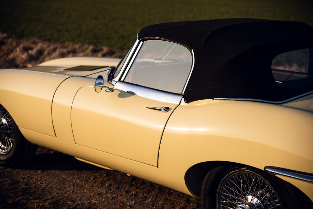 Vintage yellow convertible car with black soft top