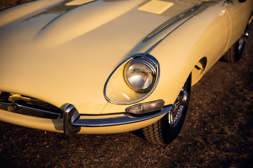 Vintage yellow Jaguar car at sunset