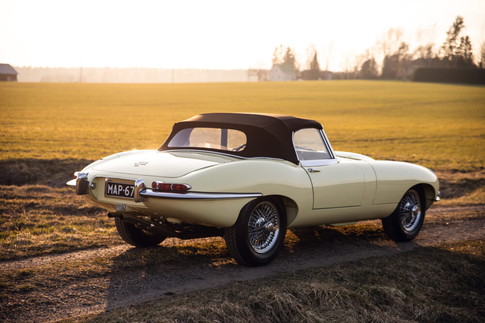 Vintage yellow convertible car parked in open field
