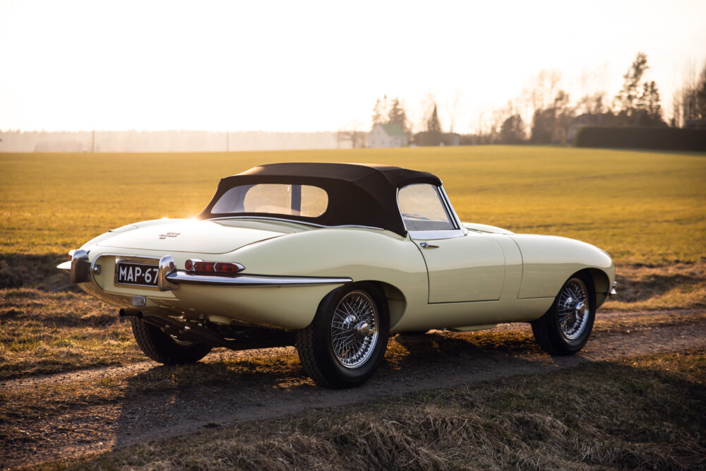 Vintage cream convertible car on sunlit field