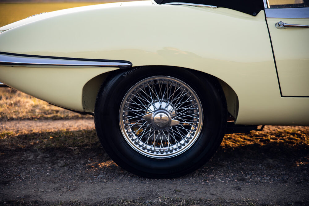 Vintage cream car with chrome wire wheel
