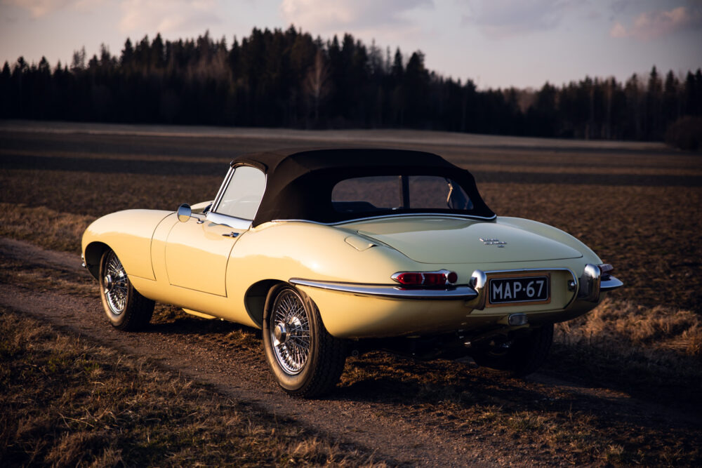 Vintage yellow convertible car parked in open field