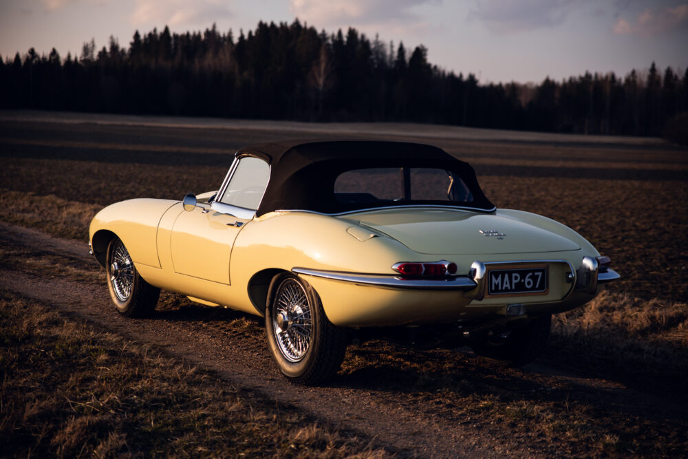 Vintage yellow convertible car in a field at dusk