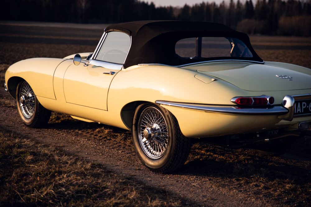 Classic yellow convertible car parked in countryside