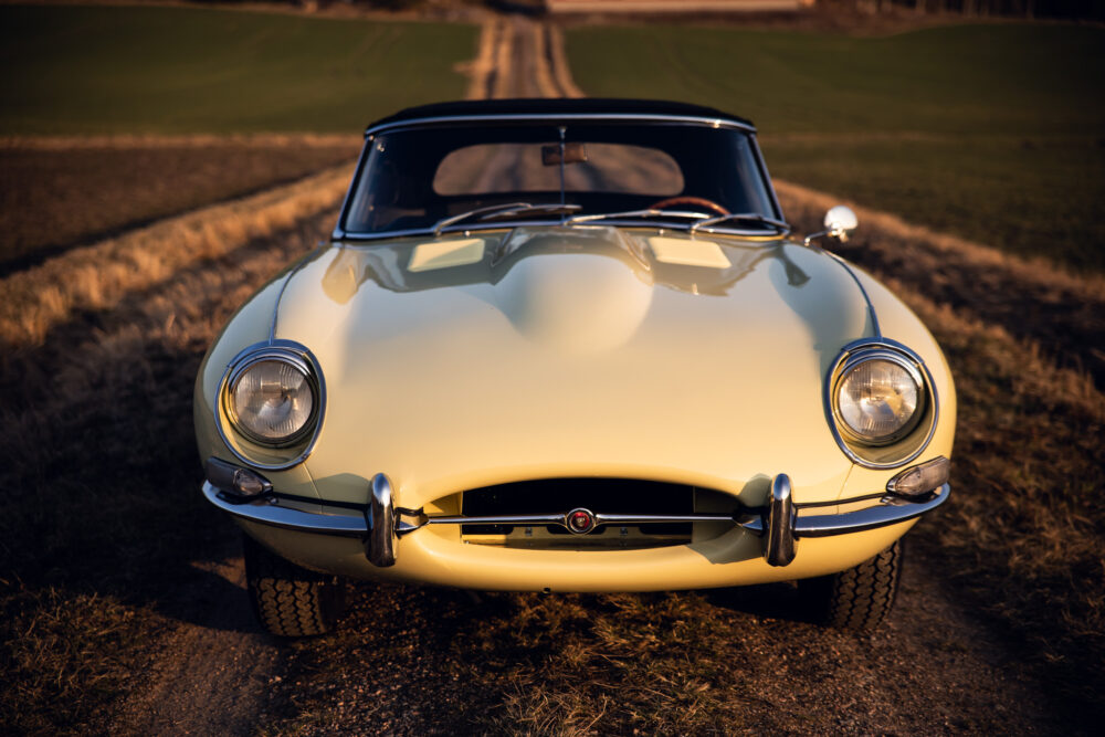 Vintage car on rural road at sunset